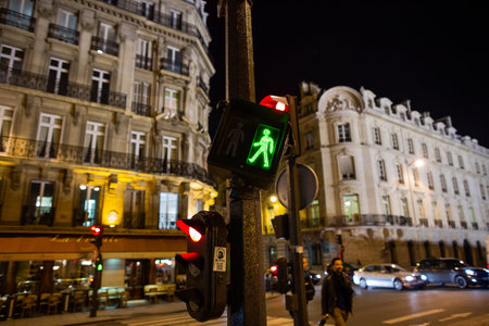 Paris, France, 1.11.2019 - Pedestrian traffic light green on street at night. romantic night walk concept.のeditorial素材