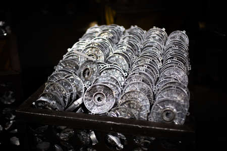 Aluminum workpieces of electric motors in dirty container at outdated factoryの写真素材