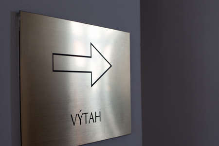 Pilsen, Czech Republic, 1.09.2019 - vytah Brass plate with directions to elevator in Czech. Pointer, concept of movement, finding way out, solving problem copy spaceのeditorial素材