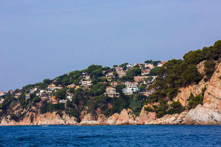 Lloret de Mar, Spain, May 1, 2020 - Private villas on high Costa Brava rocky coast. Modern mediterranean architecture, real estate with sea view. Millionaire dwelling, Gold Coastのeditorial素材