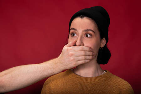 Speak no, mute, silence, subordination, me too. Young woman with closed mouth