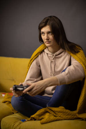 Crazy obsessed with games lady plays video game holding console gamepad in handsの写真素材