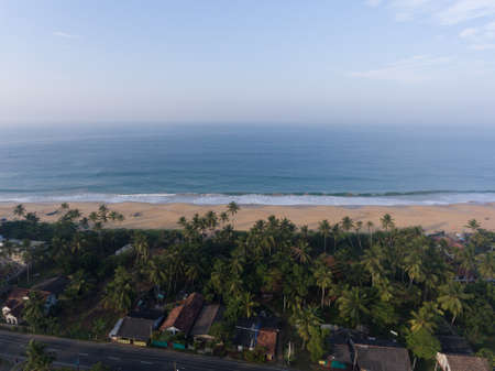 Hikkaduwa, Sri Lanka, 1.12.2020 - Amazing aerial view of Indian Ocean and beaches, cottages surrounded by tropical greenery and palm treesのeditorial素材