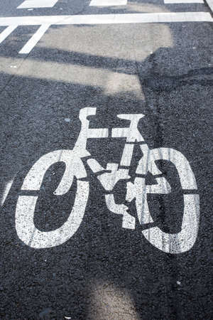 Bicycle lane markings on asphalt road in European city. Benefit for cyclists, convenience and safety of cycling concept. Copy space on empty street. Urban infrastructure, no peopleの写真素材