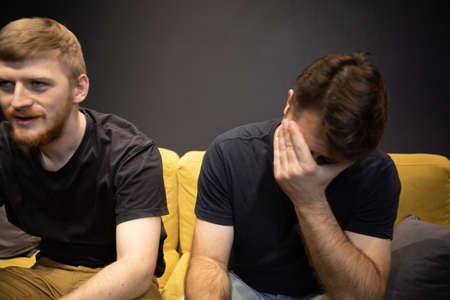 Win and lose concept. gamer covered his eyes with palm upset at losing