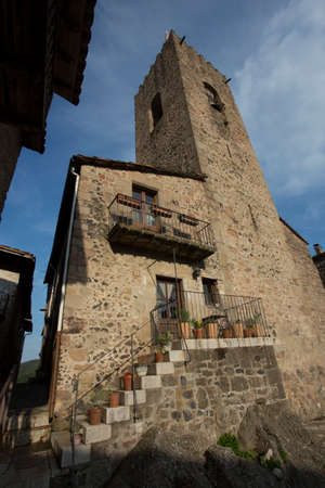 Santa Pau, Spain, May 1, 2020 - Medieval tower of old picturesque Catalan town. Typical Spanish...