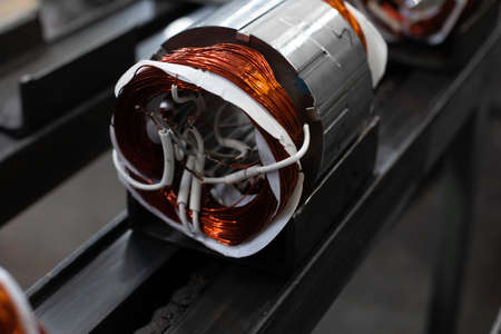 stator with copper coil on assembly line of Semi-automated manual production. electric motors manufacture in industrial company. Stator, magnetic device, part of electric motorの写真素材