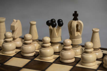White Chess pieces on board, arranged in incorrect initial position. king is not in his Chessboard square close up. Childrens formation error, chess beginners. simplest chess lesson to arrange piecesの写真素材