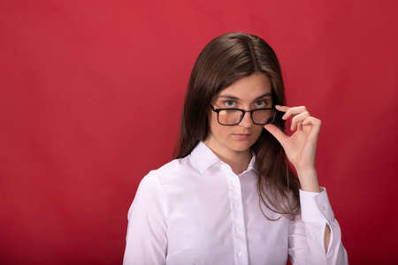 Smart female specialist in formal clothes look at camera, copy space, accountingの写真素材