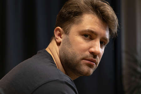 Portrait of Young unshaven handsome guy, stylish man, confident person indoorsの写真素材