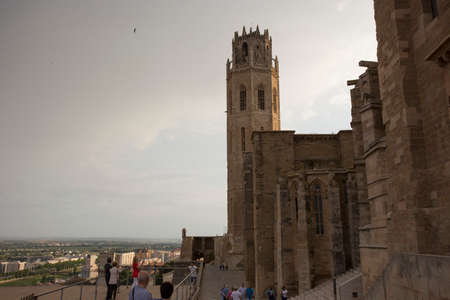 Lleida, Spain, May 1, 2020 - tower and fortress wall of La Seu Vella former Roman Catholic cathedral church under thunderclouds. Symbol of Reconquista, historical struggle between Moors and Christiansのeditorial素材