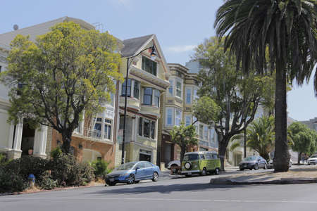 SAN FRANCISCO, CA, USA, 2.09.2020 - steep residential street with rows of houses stepping up hill, cars parked and palm trees looking up steep city streetのeditorial素材