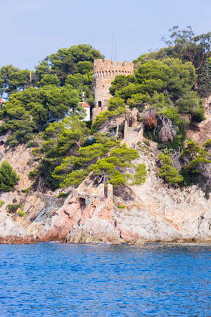 Lloret de Mar, Spain, May 1, 2020 - Castell Plajan on Costa Brava. View from Balearic Sea on rocky coast. Popular tourist destination in Catalonia.のeditorial素材