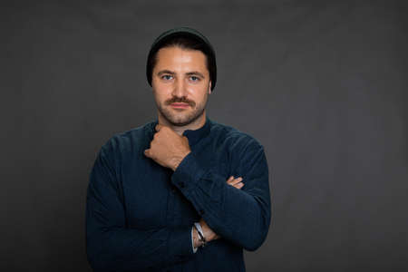 Smiling confident hipster guy in business casual on grey background, copy spaceの写真素材