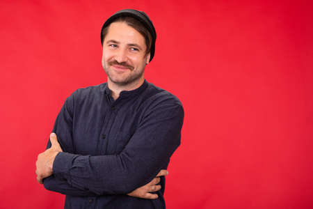 Smiling man in casual wear on red background, insurance, lending, investmentsの写真素材
