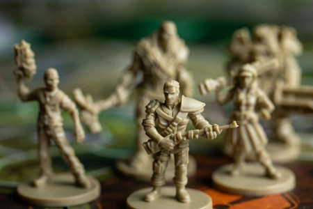 Roseville, MN, USA, 02.04.2021 - Fallout strategy Board Game Plastic Figures on facedown Map Tile selective focus. Five pieces. four players Home fun Based on post-apocalyptic computer game Falloutのeditorial素材