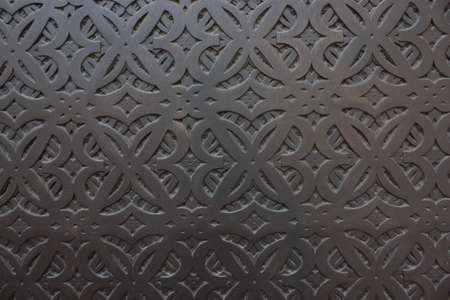 Pattern on dark vintage doors. Screensaver for phone or laptop, Barcelona architectural heritage. Abstract lines and curls. idea for furniture design or wood processingの写真素材
