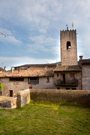 Santa Pau, Spain, May 1, 2020 - Medieval tower of old picturesque Catalan town. Welcome to Catalonia Concept Copy space. Typical Spanish architecture, historical heritage, architectural monumentsのeditorial素材