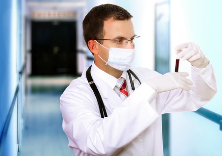 Doctor  resarch a medical test glass with blood in Hospital.の写真素材