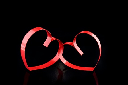 St. Valentine Day. Two hearts, on black background with reflection.の写真素材