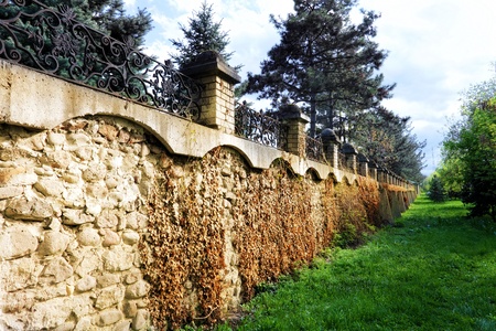 Fence placed a long brick wall. 