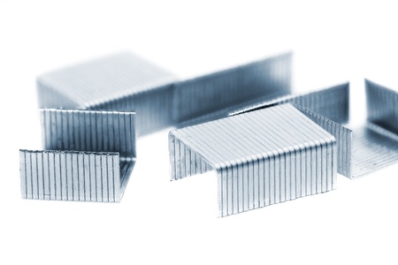 Stack of metal staples. Isolated on a white background.の写真素材