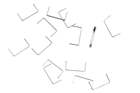 Stack of metal staples. Isolated on a white background.の写真素材