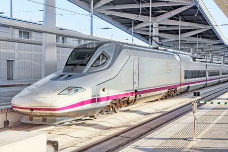 Modern high speed train at the railways station .