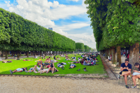 PARIS, FRANCE - JULY 08, 2016 : Parisians and tourists have a rest on the lawn near the Luxembourg Palace. Paris. France.のeditorial素材