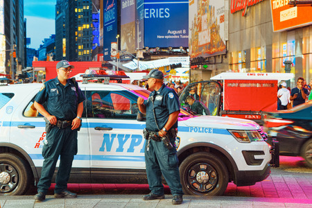 New York, USA- September 06, 2017 : Policeman and police car of New York. Financial capital of America is New York City.のeditorial素材