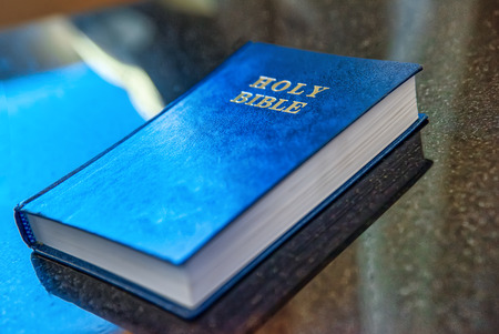 The book Holy Bible lies on the table.の写真素材