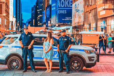 New York, USA- September 06, 2017 : Policeman and police car of New York. Financial capital of America is New York City.のeditorial素材