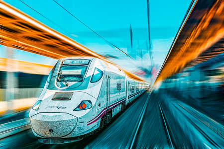 Madrid, Spain - June 08, 2017: Modern hi-speed passenger train of Spanish Railways Company - Renfe, in movement (motion).のeditorial素材