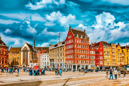 AMSTERDAM, NETHERLANDS - SEPTEMBER 15, 2015: Beautiful Amsterdam, people in the centre of  Dam Square in the daytime.Square is a central place for local inhabitants and tourists of the Dutch capital. Netherlandsのeditorial素材