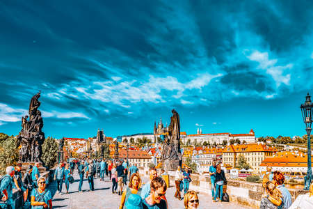 PRAGUE,CZECH REPUBLIC- SEPTEMBER 13, 2015: View of Prague and Charles Bridge with people -famous historic bridge that crosses the Vltava river in Prague, Czech Republic.のeditorial素材