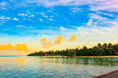 Beautiful evening sunset on the coast of the island. Maldives Islands.の写真素材