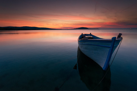 Lonely boat at sunsetの写真素材