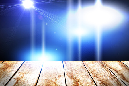 concert spot lighting over dark background and wood floorの写真素材