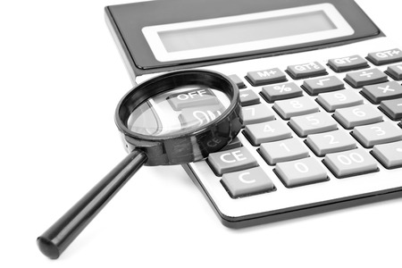 Calculator with a magnifying glass on a white backgroundの写真素材