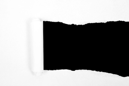 Torn black paper with brown backgroundの写真素材