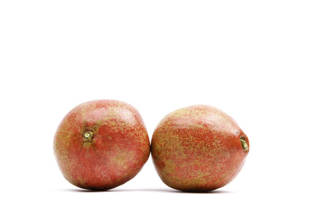 red sliced pomegranate on a white backgroundの写真素材