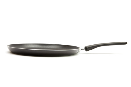 black frying pan isolated on white backgroundの写真素材