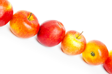 juicy red apples isolated on whiteの写真素材