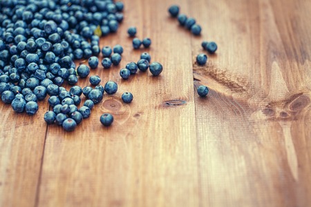 Blueberries over old wooden table.の写真素材