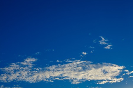Blue sky with white and grey cloudsの写真素材