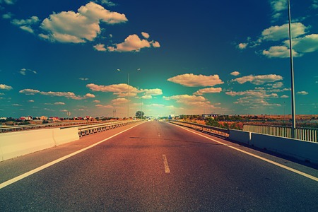 speed asphalt-paved road anchorwoman from a cityの写真素材