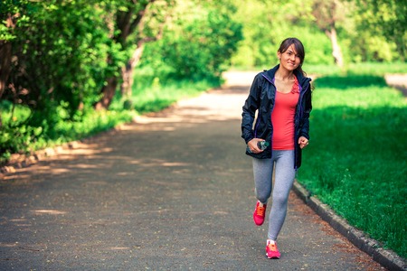 a girl drinks water after sportの写真素材