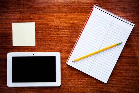 notebook isolated on a wooden backgroundの写真素材