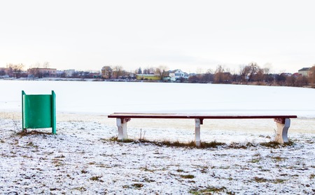 bench snow the small riverの写真素材
