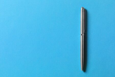 metal pen isolated on blue background